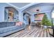Bright living room with hardwood floors, comfortable seating, and a large American flag at 13181 Linzia Ln, Spring Hill, FL 34609