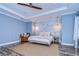 Main bedroom with wood-like flooring and accent wall at 13181 Linzia Ln, Spring Hill, FL 34609