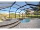 Relaxing screened pool and spa with lounge chairs at 13181 Linzia Ln, Spring Hill, FL 34609