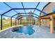 Enjoy this refreshing screened pool and spa with a stone feature at 13181 Linzia Ln, Spring Hill, FL 34609