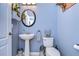Small but stylish powder room with pedestal sink and updated fixtures at 13181 Linzia Ln, Spring Hill, FL 34609