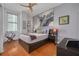 Cozy bedroom with hardwood floors and large wall art at 1120 E Kennedy Blvd # 1221, Tampa, FL 33602