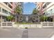 Modern building entrance with a sleek glass enclosure and landscaping at 1120 E Kennedy Blvd # 1221, Tampa, FL 33602