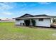 Home's exterior side and a large backyard at 1201 Harkness Way, Sun City Center, FL 33573