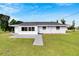 House exterior and expansive grassy backyard at 1201 Harkness Way, Sun City Center, FL 33573