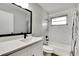 Bright bathroom includes white subway tile, quartz counters and black hardware at 1201 Harkness Way, Sun City Center, FL 33573