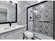 Modern bathroom showcases decorative shower tile, quartz countertop, and black fixtures at 1201 Harkness Way, Sun City Center, FL 33573
