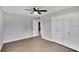 Bedroom featuring wood-look flooring, white trim, and a double closet at 1201 Harkness Way, Sun City Center, FL 33573