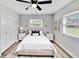 Neutral primary bedroom with a ceiling fan, bright windows, and clean decor at 1201 Harkness Way, Sun City Center, FL 33573