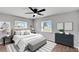 Bright bedroom features a ceiling fan, neutral walls, and well-lit windows at 1201 Harkness Way, Sun City Center, FL 33573