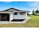 Side view of a newly renovated light blue house with a yard at 1201 Harkness Way, Sun City Center, FL 33573