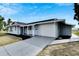 The house features a one car garage and freshly poured concrete driveway, enhancing curb appeal at 1201 Harkness Way, Sun City Center, FL 33573