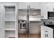 Modern kitchen with stainless steel refrigerator and pantry at 1201 Harkness Way, Sun City Center, FL 33573