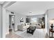 Spacious living room with modern decor, gray walls, and L-shaped sectional sofa at 1201 Harkness Way, Sun City Center, FL 33573