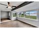 Bright living room with wood-look floors and large windows overlooking the backyard at 1201 Harkness Way, Sun City Center, FL 33573