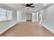 Empty living room with plank floors and a ceiling fan at 1201 Harkness Way, Sun City Center, FL 33573