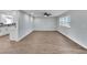 Open living room featuring new flooring, modern paint, and adjacent to the kitchen at 1201 Harkness Way, Sun City Center, FL 33573