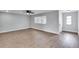 Bright open living room with new flooring, modern paint, and large windows at 1201 Harkness Way, Sun City Center, FL 33573