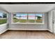 Bright sunroom features a wall of windows looking onto the yard at 1201 Harkness Way, Sun City Center, FL 33573