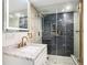 Modern bathroom featuring a sleek vanity, elegant fixtures, and a luxurious glass-enclosed shower with dark marble at 12506 Forest Hills Dr, Tampa, FL 33612