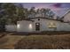 Charming single-story home featuring a well-maintained lawn, decorative lighting, and a welcoming front entrance at 12506 Forest Hills Dr, Tampa, FL 33612