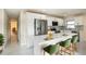 Modern kitchen featuring sleek white cabinetry, stainless steel appliances, waterfall island, and stylish backsplash at 12506 Forest Hills Dr, Tampa, FL 33612