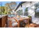 A delightful outdoor dining area on a wood deck features a table and chairs, as well as comfortable seating at 12506 Forest Hills Dr, Tampa, FL 33612