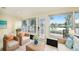 Cozy sun room with wicker furniture, large windows, and a door with serene lake view, perfect for relaxation at 12506 Forest Hills Dr, Tampa, FL 33612