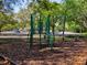 playground with modern equipment and wood chips at 13209 Woodward Dr, Hudson, FL 34667