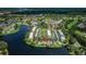 Aerial view of condo community, showing lakefront property, mature trees, and well-manicured green spaces at 165 Nina Way, Oldsmar, FL 34677