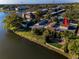 Aerial view of a waterfront condo featuring lush landscaping and serene lake views at 165 Nina Way, Oldsmar, FL 34677