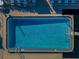 Aerial view of community pool area with clear blue water and chairs surrounding the pool at 165 Nina Way, Oldsmar, FL 34677