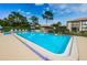 Community pool with ample seating for relaxing on sunny days at 165 Nina Way, Oldsmar, FL 34677