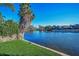 A panoramic view of a tranquil lake surrounded by well-maintained lawns and residential buildings at 165 Nina Way, Oldsmar, FL 34677