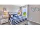 Nautical-themed bedroom with striped bedding, window seat, and decorative wall hangings at 18125 Canopy Pl, Lakewood Ranch, FL 34211