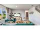 Living Room with teal couch, wooden coffee table, and a view of backyard at 18125 Canopy Pl, Lakewood Ranch, FL 34211