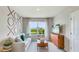 room with a neutral couch and wooden entertainment center at 18125 Canopy Pl, Lakewood Ranch, FL 34211