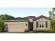 One-story home with a two-car garage and landscaped front yard at 18154 Beach Ranch Ter, Lakewood Ranch, FL 34211