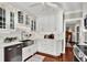 Modern kitchen with white cabinets, farmhouse sink, and stainless steel appliances at 2220 12Th N St, St Petersburg, FL 33704