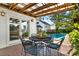 Relaxing patio with pool, outdoor dining, and lush landscaping at 2220 12Th N St, St Petersburg, FL 33704