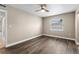 Spacious bedroom featuring wood-look floors and a large window at 3207 River Cove Dr, Tampa, FL 33614