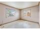 Simple bedroom with two windows and terrazzo flooring at 3207 River Cove Dr, Tampa, FL 33614