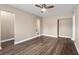 Light bedroom with wood-look floors and access to bathroom at 3207 River Cove Dr, Tampa, FL 33614