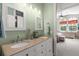 Bathroom with double sinks, granite countertop and views into the bedroom at 354 Larboard Way, Clearwater Beach, FL 33767