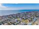 Aerial view of coastal neighborhood, showcasing homes and ocean at 409 161St Ave, Redington Beach, FL 33708
