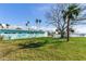 Spacious backyard with large tree and grassy area, perfect for outdoor enjoyment at 409 161St Ave, Redington Beach, FL 33708