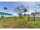 Large backyard with grass and a large tree in the center at 409 161St Ave, Redington Beach, FL 33708