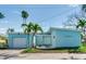 Charming light blue home with attached garage and tropical landscaping at 409 161St Ave, Redington Beach, FL 33708