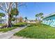 Landscaped side yard with mature tree and walkway at 409 161St Ave, Redington Beach, FL 33708