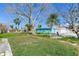 Spacious grassy side yard with mature tree at 409 161St Ave, Redington Beach, FL 33708